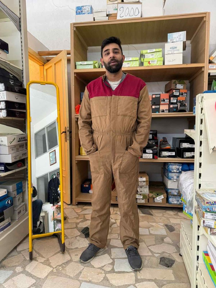 Straniero mostra soddisfatto il suo camice di lavoro.